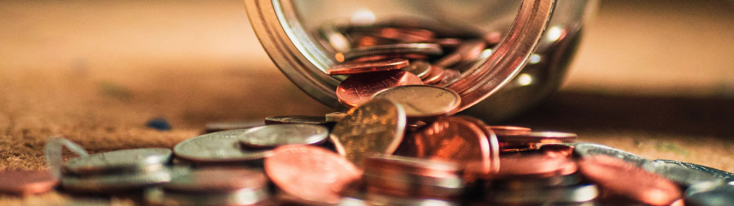 Coins spilling out of a jar