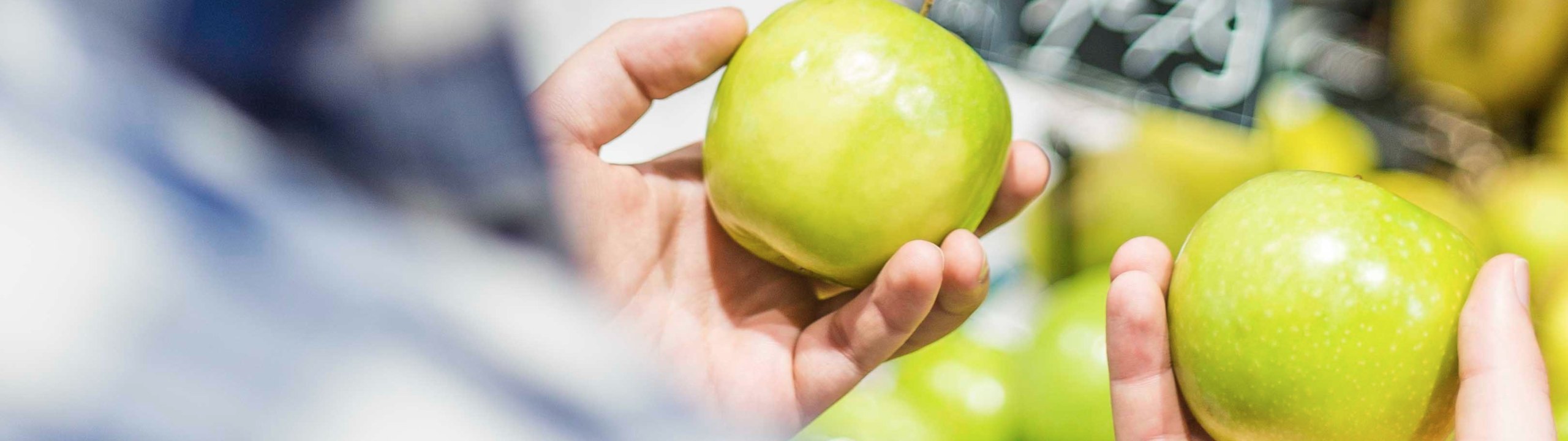 Man holding two apples.