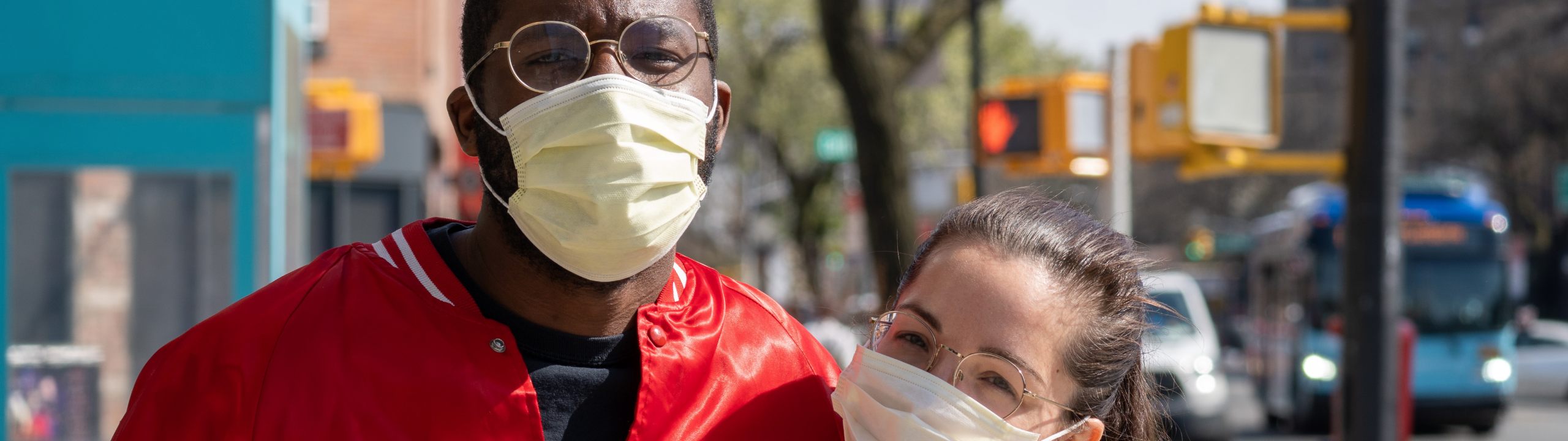 two people wearing glasses and face masks