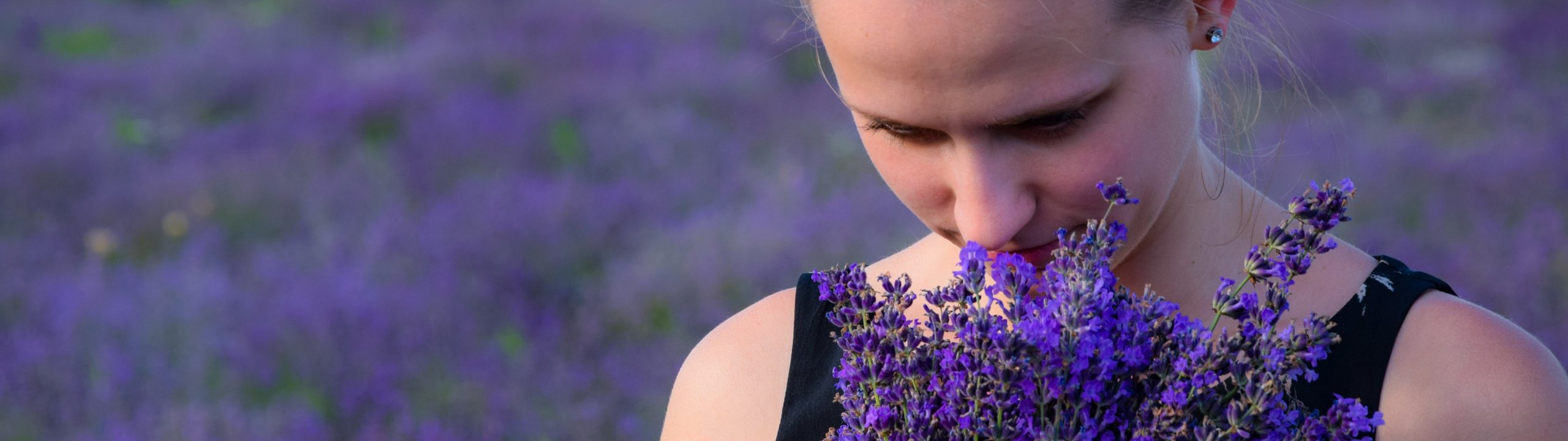 person smelling flowers