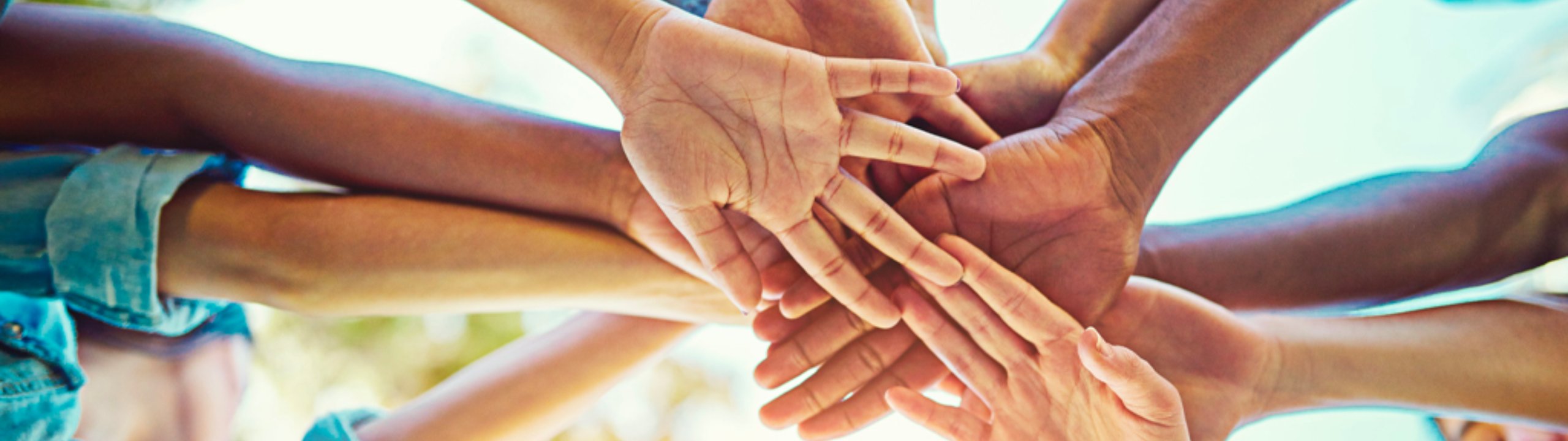 Hands together in a team huddle.