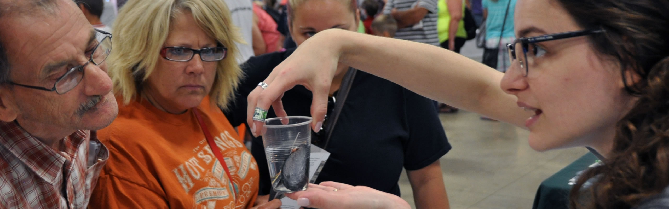 NCSE Graduate Student demonstrating to three adult participants.