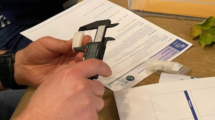 A teacher participant measuring a horse tooth.