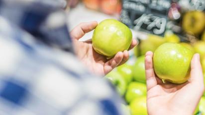 Man holding two apples.