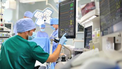 Medical worker checking a display.