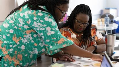 Two teaches engaged in a professional learning activity.