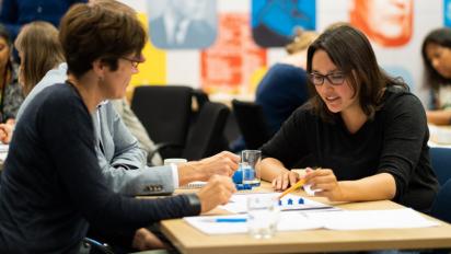 a group of people in conversation at a table